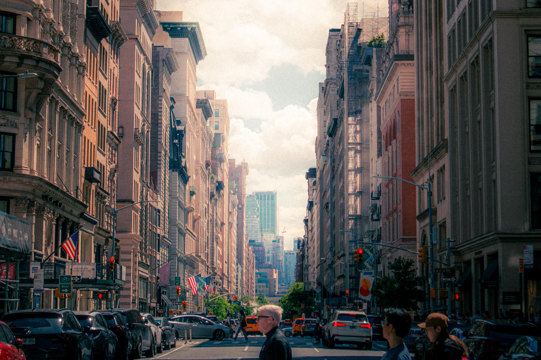 Looking down a wide New York City avenue in late afternoon light